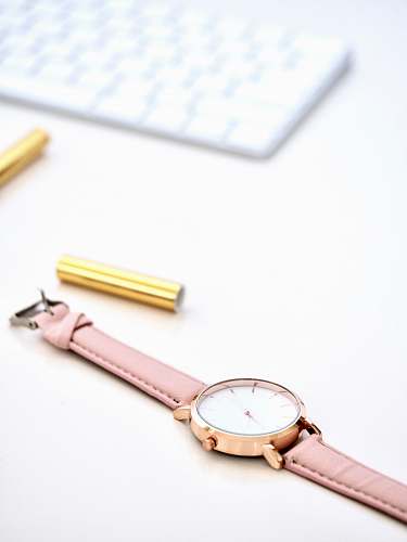 australia round gold-colored framed analog watch on white surface watch